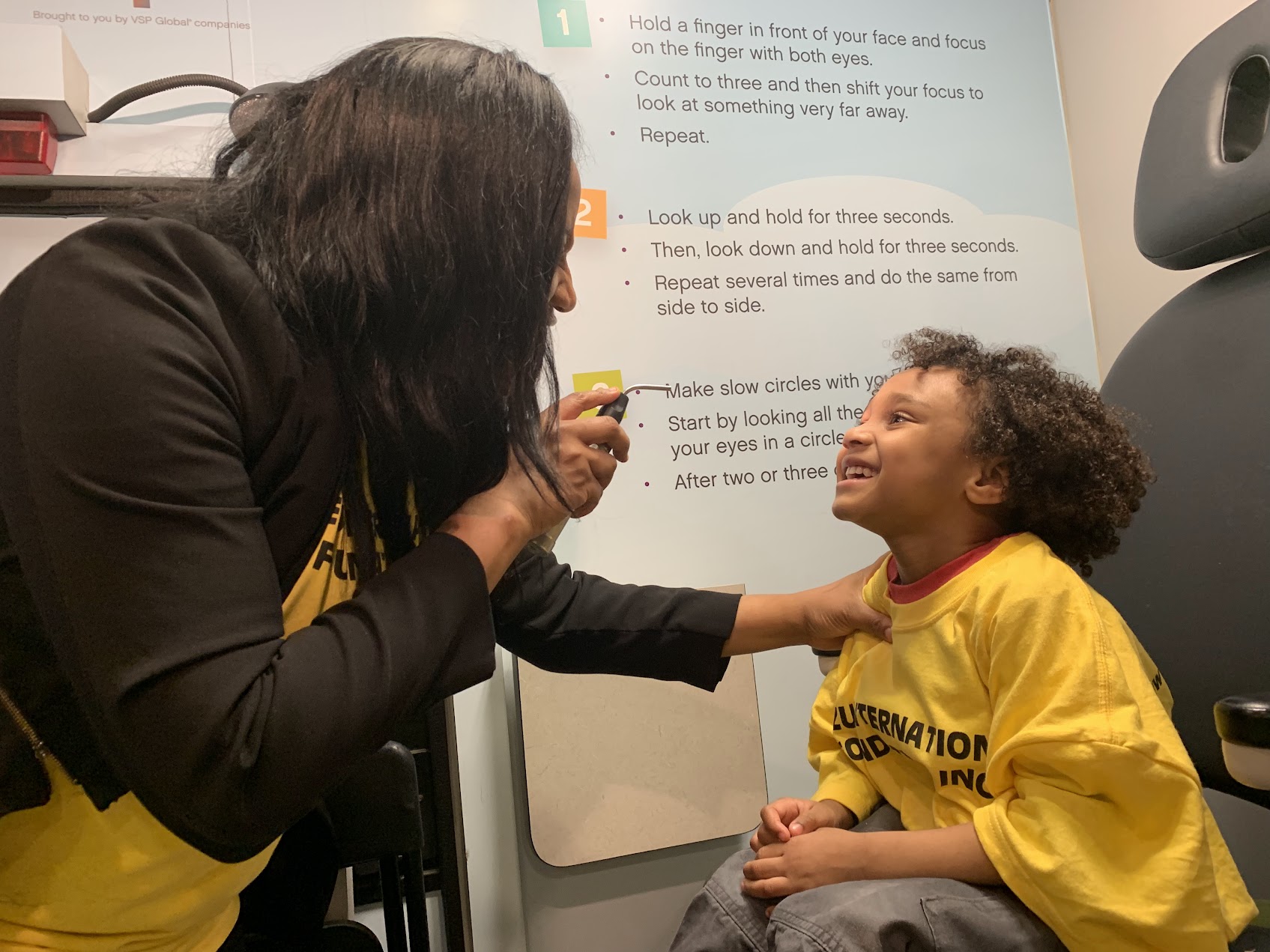 Families receiving free vision screenings at a Mezu International Foundation health and vision fair.